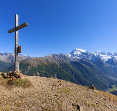 The cross at the peak of a mountain